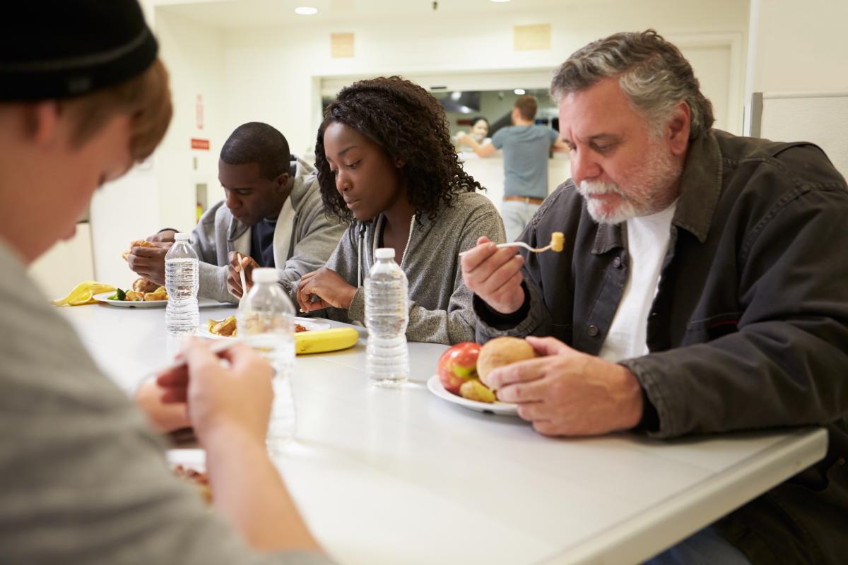 group of people eating around a table